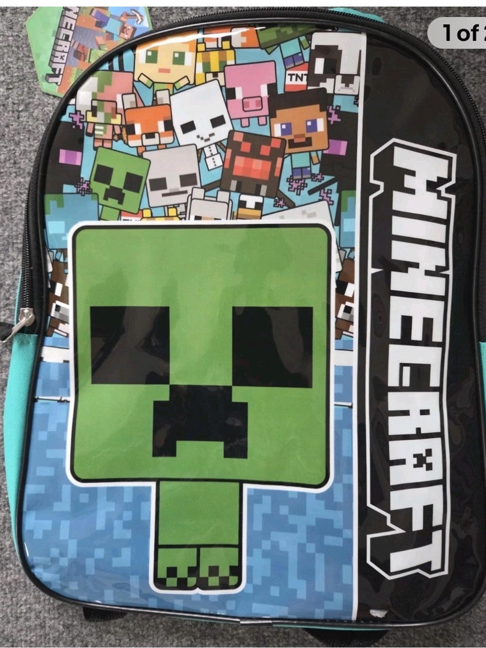 The product is a Minecraft-themed 15" full-size zippered backpack with an adjust